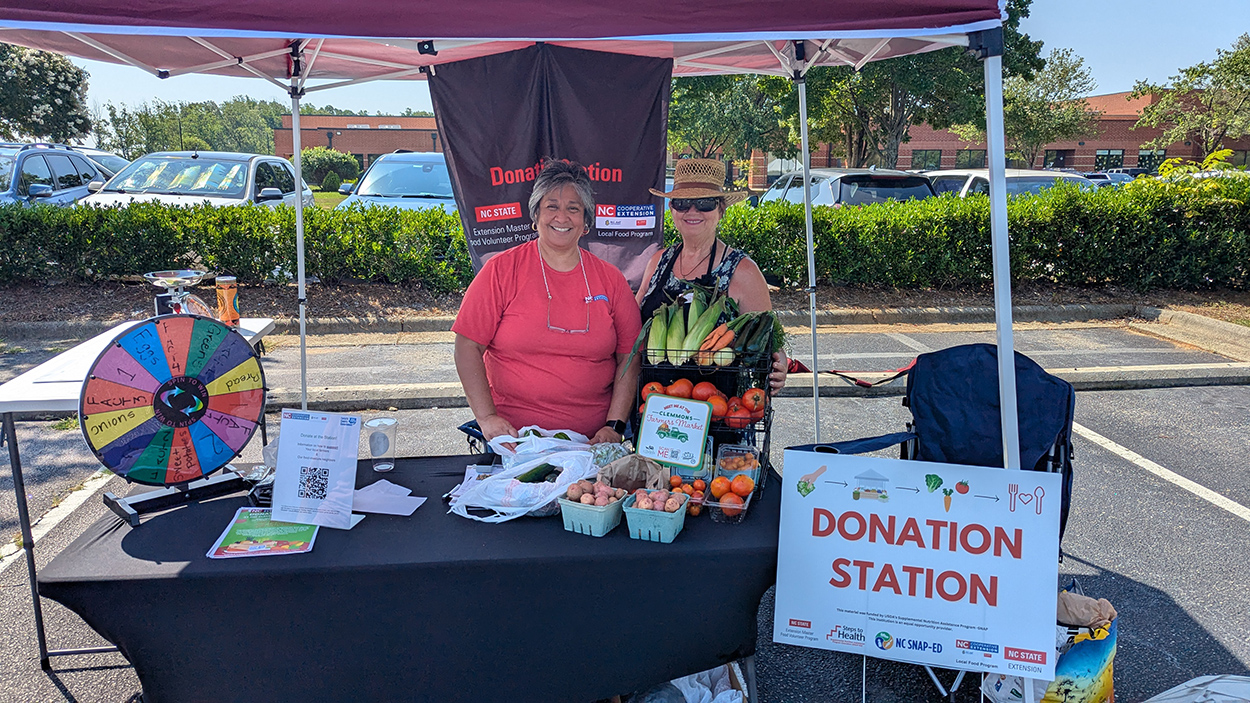 Cooperative Extension staff at the Donation Station at the Clemmons Farmers Market